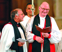 Bishop Kenneth shares a joke with the dean during his comeback service at the cathedral