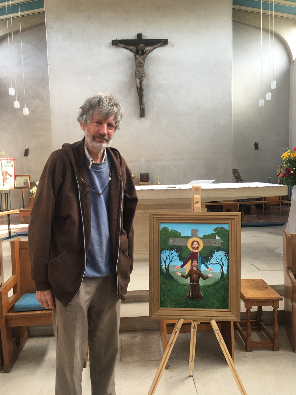 Brother Hugh SSF stands beside the new icon.
