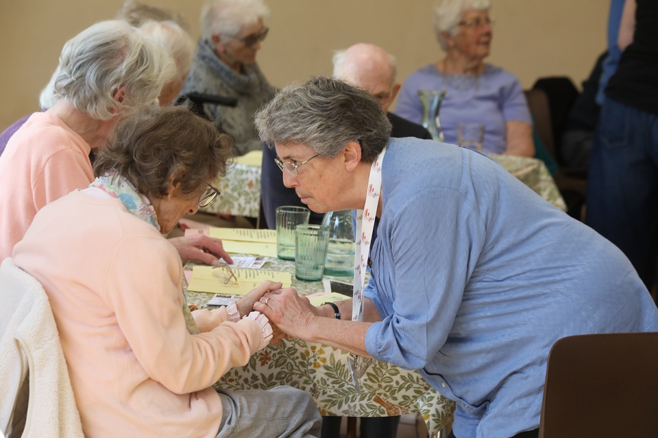 Anna Chaplain Caroline Free offers prayers for one of those attending the Anna Café Church