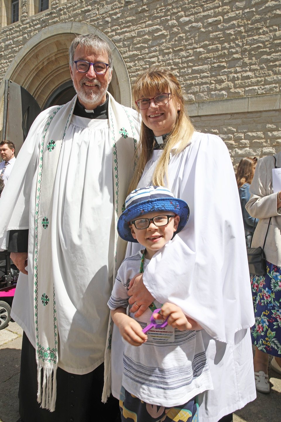 Canon Tom Kennar with his daughter, the newly-ordained Emily Ashworth, and her son Lucas