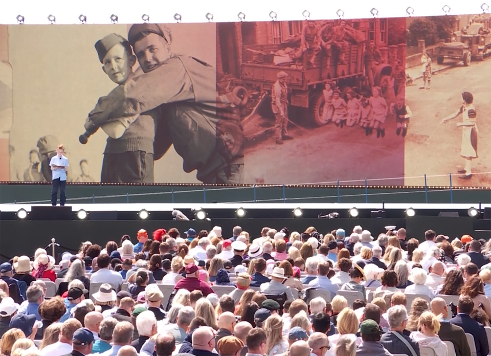 Luca Shaw reading on the giant stage erected on Southsea Common for the D-Day 80 commemorative event