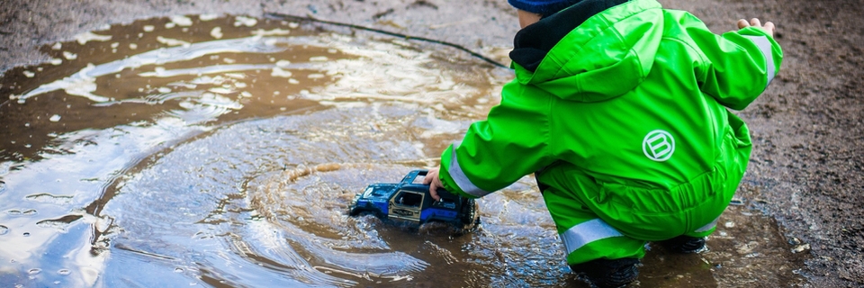 Child playing in puddle