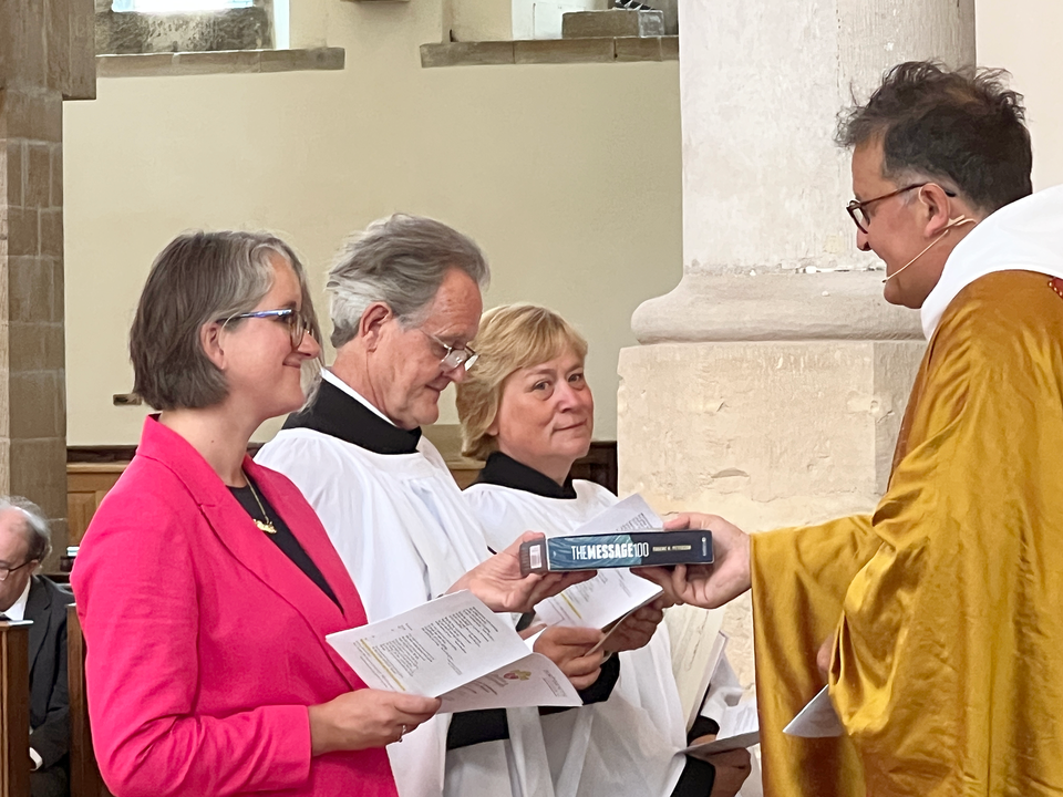 The readers and pioneer minister are presented with bibles as a licensing gift