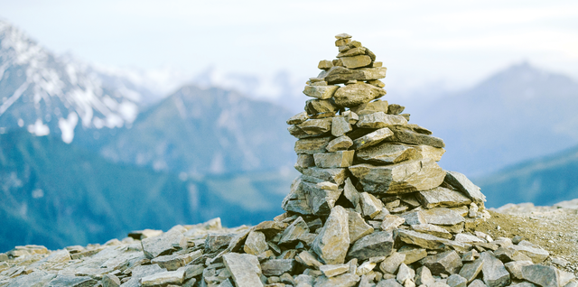 A cairn on a mountain-top is a place for us to stop and check our bearings