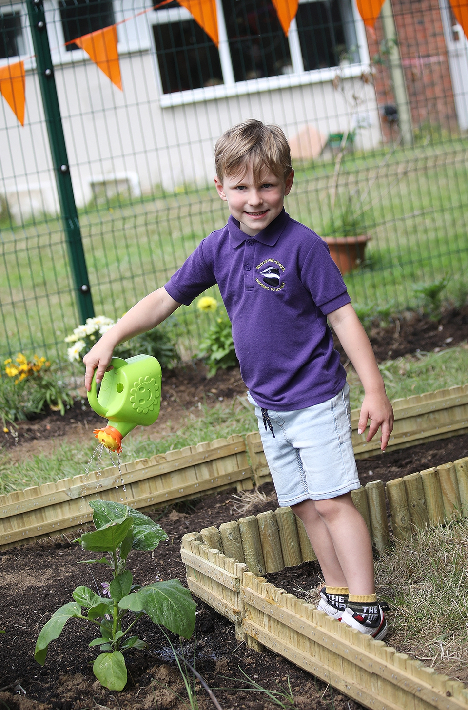 Fray Colborn, aged 4, from Badger Pre-School in Gosport, enjoys watering the flowers in the allotment space outside St Matthew’s Church, Bridgemary