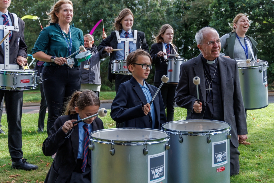 The Archbishop of Canterbury playing samba drums at the Bay C of E School in Sandown