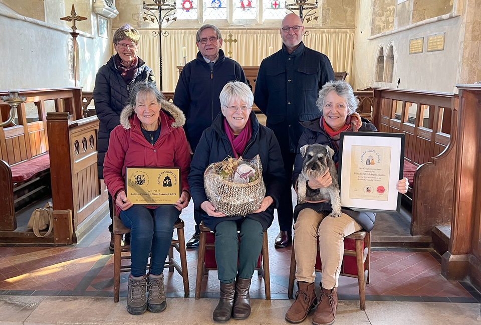 Church wardens Sarah Iredale (holding the plaque) and Jane Hussey (holding the hamper), along with some members of the congregation.