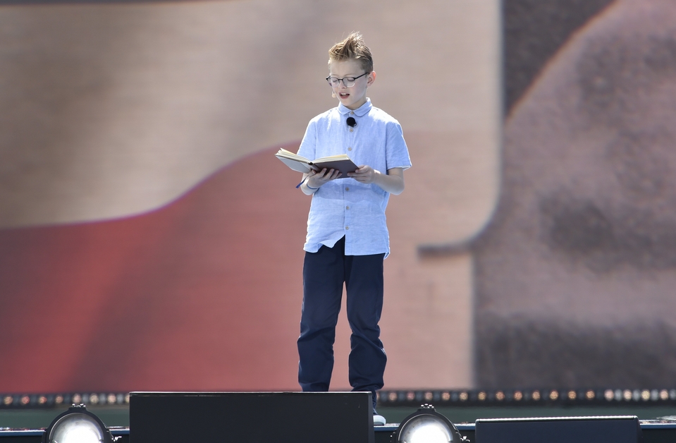 Chorister Luca Shaw reading an account by 12-year-old Trevor Butler during the D-Day 80 event on Southsea Common