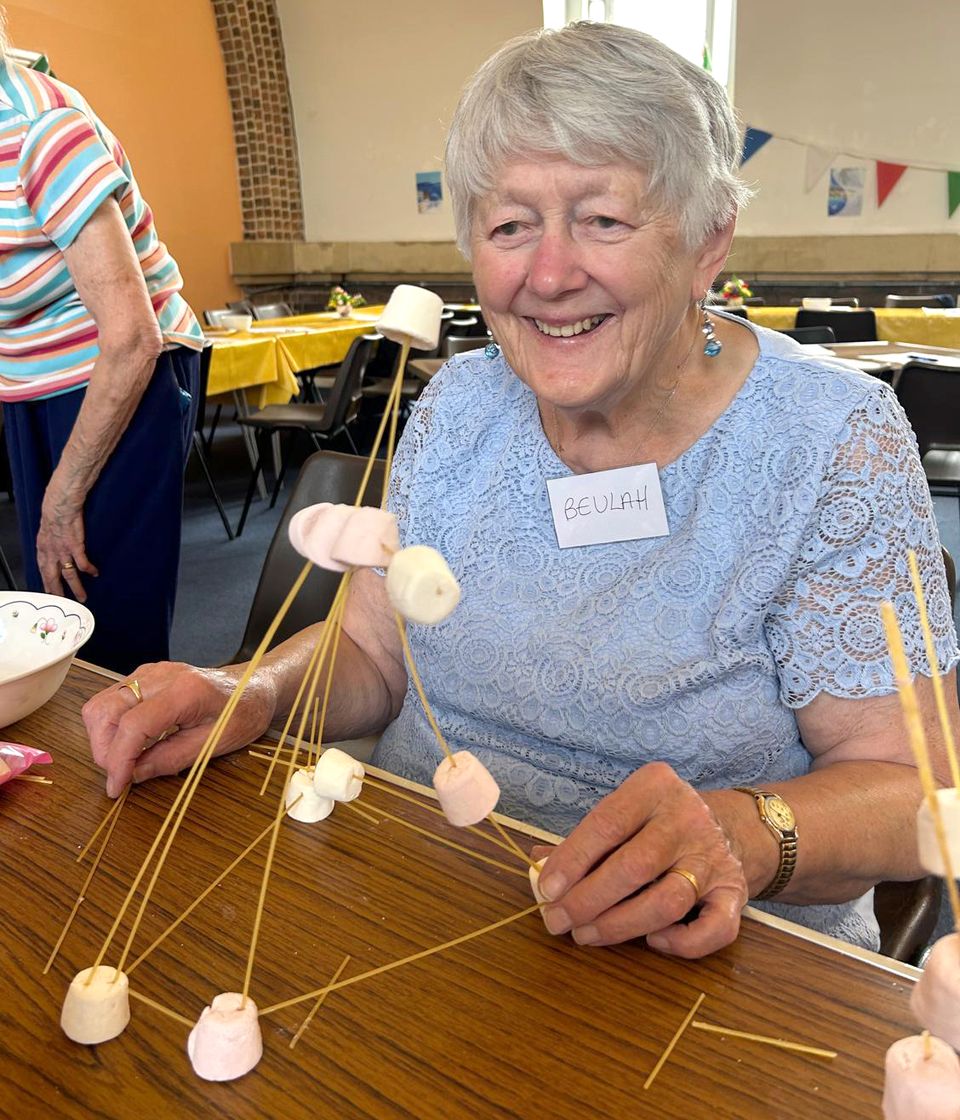 Beulah Walters making a leaning tower out of spaghetti and marshmallows