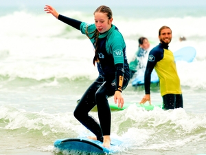 Teenagers ride the waves on surfing holiday